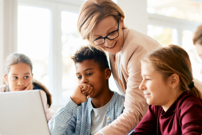 Teacher helping her students